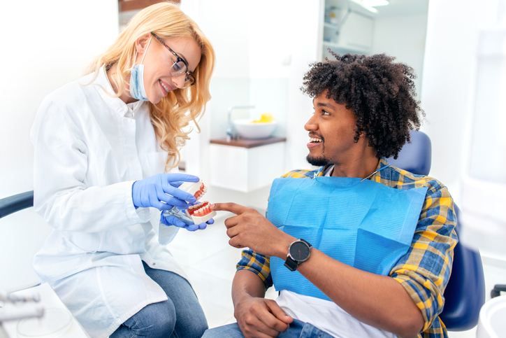 a woman getting her teeth checked by a dentist.