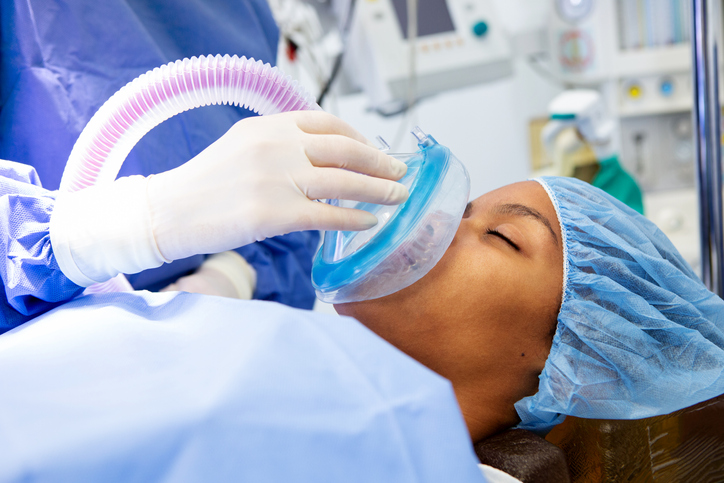 a person in a operating room getting oxygen.