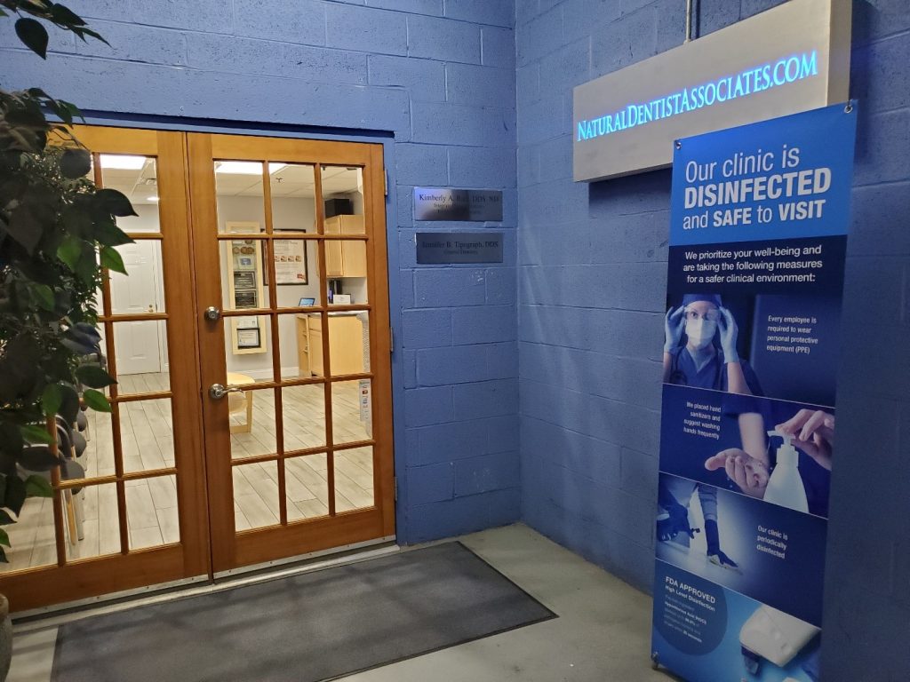 a blue wall with a sign that says our clinic is disinfected and.