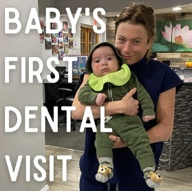 a woman holding a baby in her arms with the words baby's first dental.